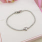 AURORA slim ~ ACCIAIO INOSSIDABILE - Bracciale tennis in cubic zirconia con cuore centrale