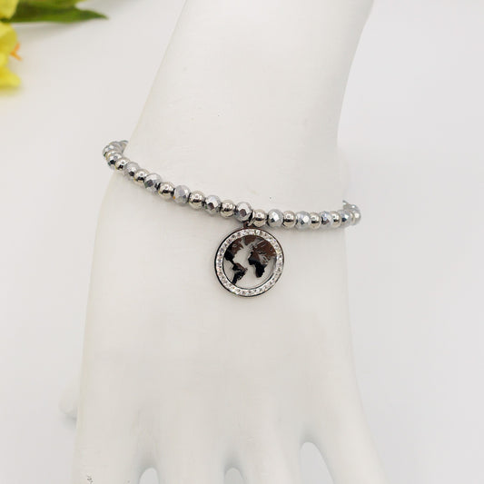 WANDERLUST ~ ACCIAIO INOSSIDABILE-  Bracciale elastico con ciondolo mondo e CUBIC ZIRCONIA