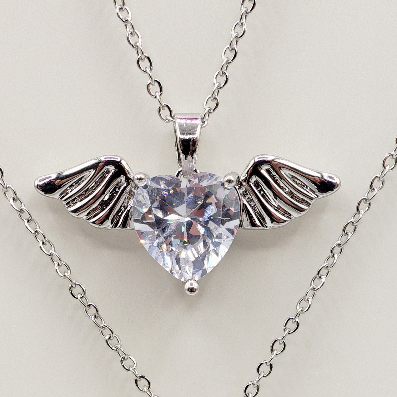 ANGEL - ACCIAIO INOSSIDABILE- collana con pendente CUORE con ali in cubic zirconia